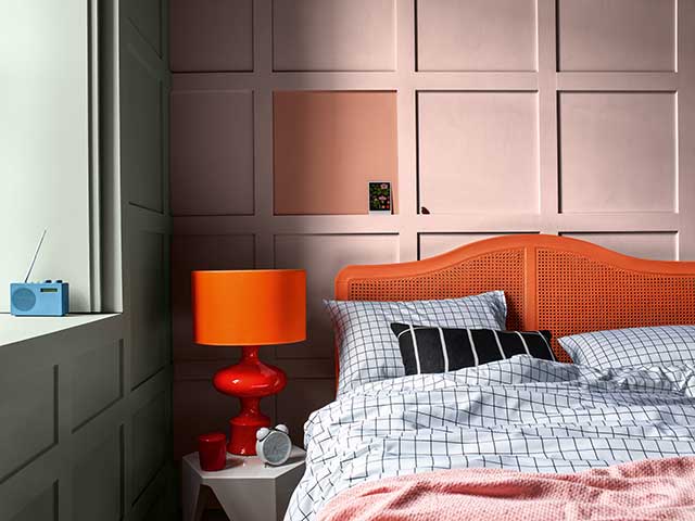 Pink panelled walls in bedroom with vibrant accessories