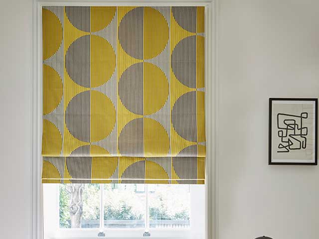 Roller blind with mustard and grey circles on white walls
