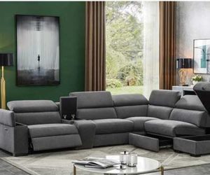 Dark grey corner DFS Storeaway sofa with ottoman storewage in living room with green walls and cream rug