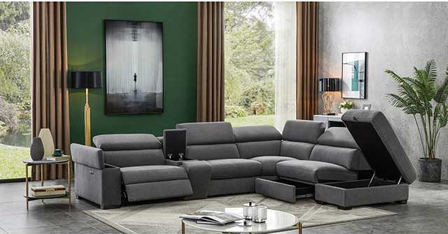 Dark grey corner DFS Storeaway sofa with ottoman storewage in living room with green walls and cream rug