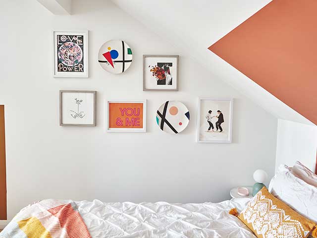 Gallery wall in bedroom of colourful Victorian terrace