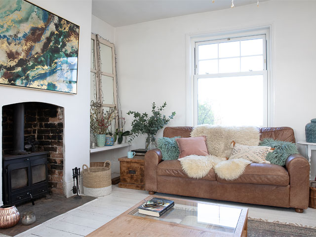 The living room of a Northumberland coastal cottage made cosy with textures and artwork 