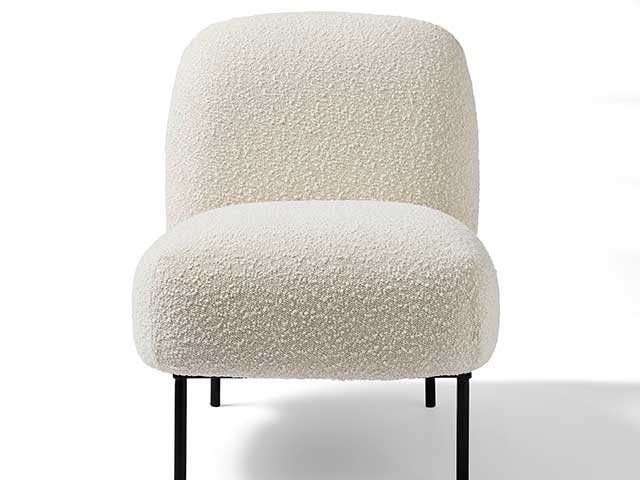 Boucle chair with black legs on white background