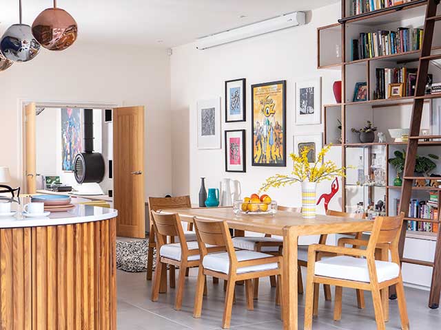 Wooden furniture and kitchen island with frame wall and floor to ceiling ladder bookcase in new build home in York 