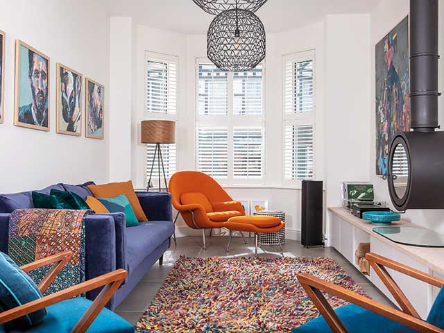 Vibrant furniture adds a pop of colour to the white walls and neutral palette in the living room