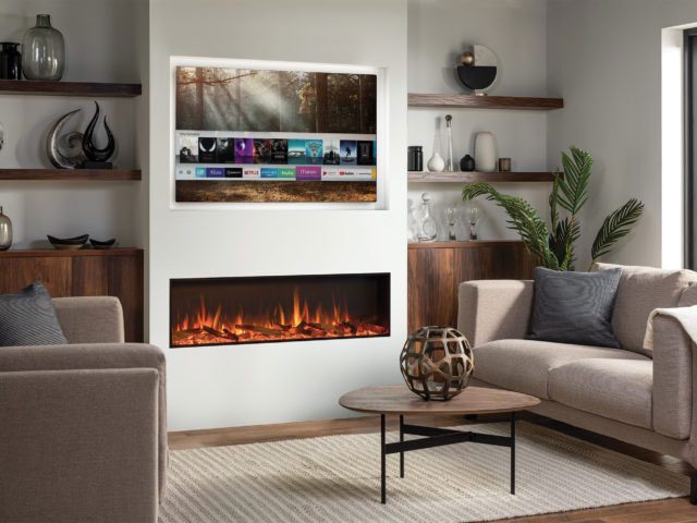 Living room with white walls, walnut shelving in alcove and media wall featuring a TV and Stovax electric fire with log effect