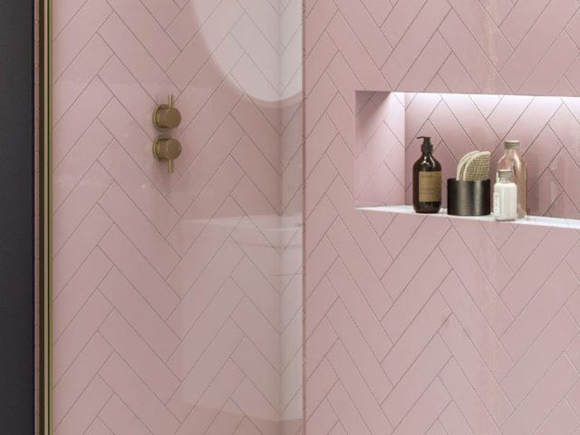 pink chevron bathroom tiles paired with grey painted walls and recessed shower shelf