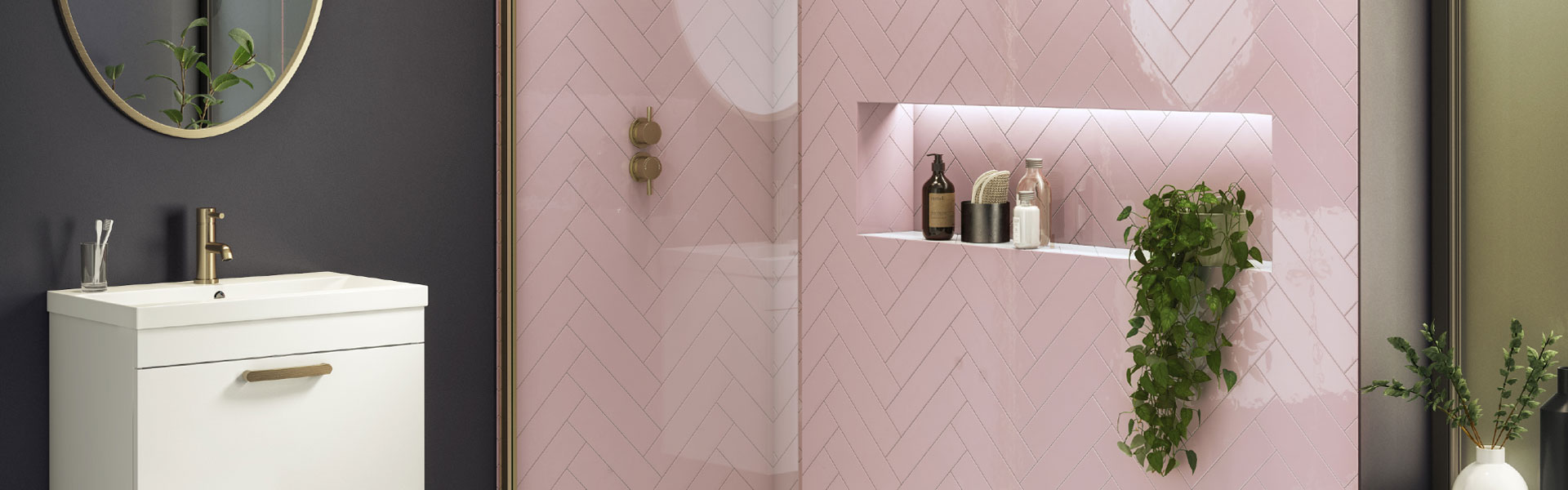 pink chevron bathroom tiles paired with grey painted walls and recessed shower shelf