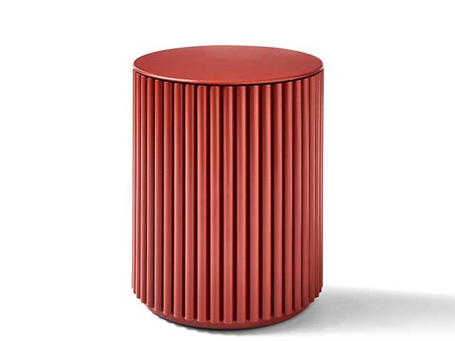 Red ribbed end table from Henry Holland on white background