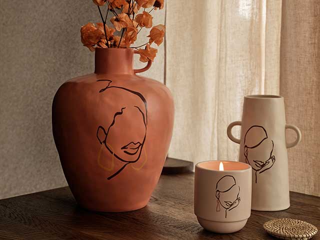 H&M Love of Art stoneware vases on wooden table with candle