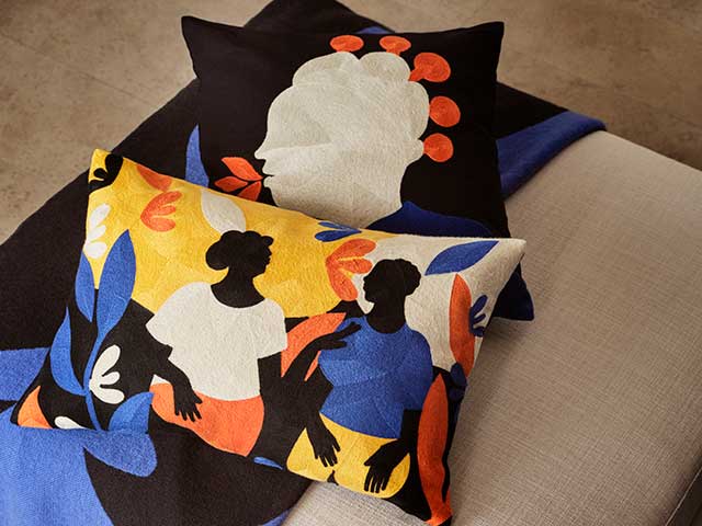 Patterned cushion covers and blankets on cream seat