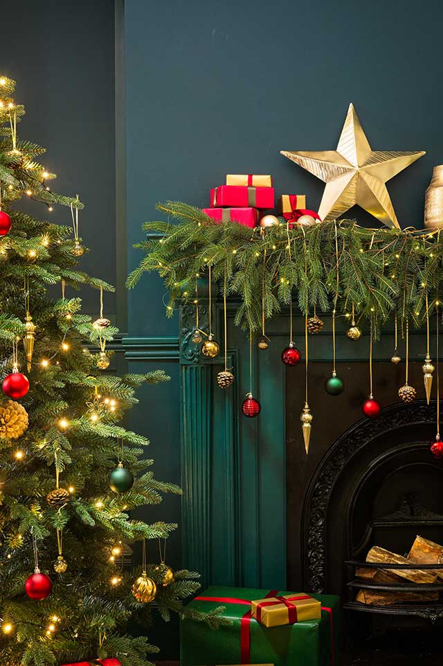 Christmas decorations, tree and fireplace garden with baubles and stars