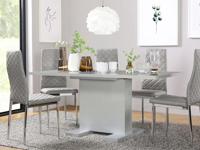 grey gloss dining table with grey faux-leather chairs and modern artwork on the walls