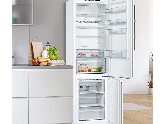 Bosch fridge freezer in white in white kitchen with laminate flooring