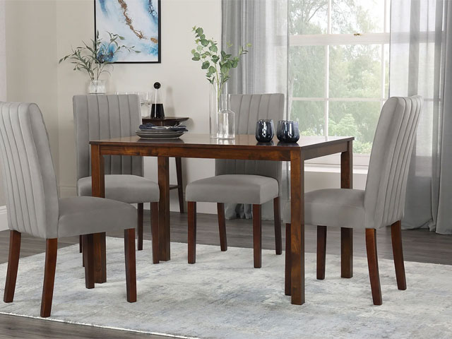 dark wood dining table with velvet seats in mink on a grey rug in a modern dining room