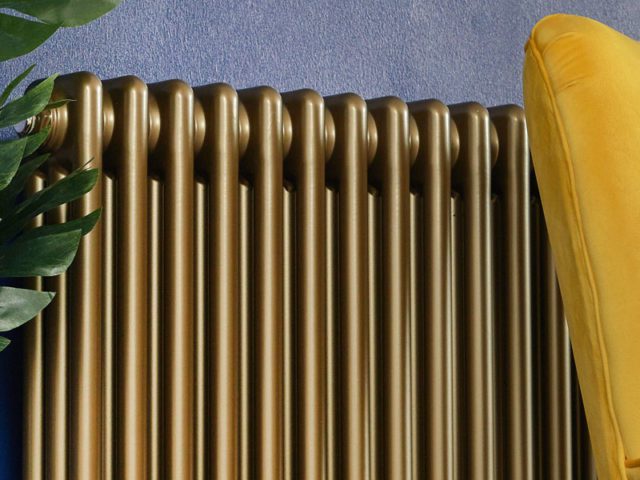 gold radiator with yellow accent chair and green plant