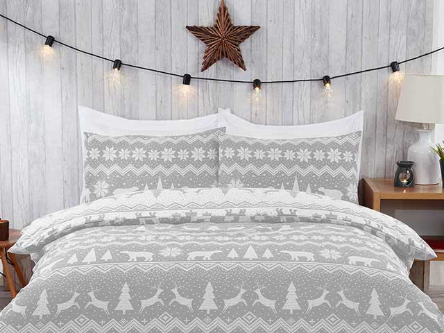 Grey fair isle bedding with fairy lights hung above