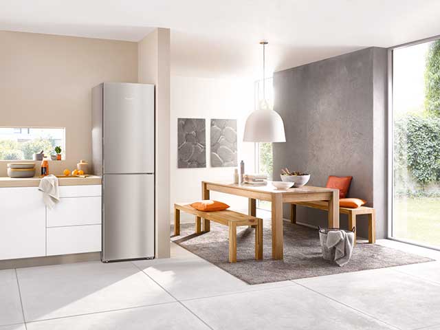 Fridge freezer in kitchen diner with wooden bench seating