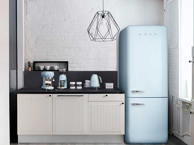 Blue smeg fridge freezer in black and white kitchen