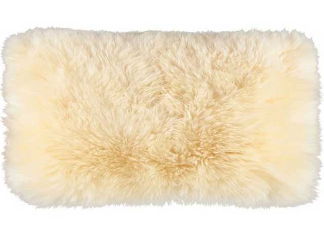 Cream fluffy oblong cushion on white background