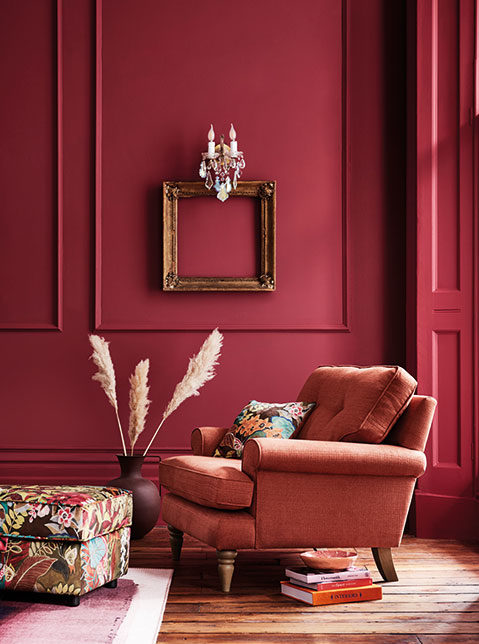 Cranberry colour scheme wall paint, accent chair and and accessories