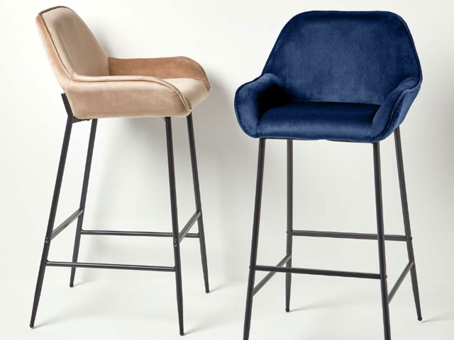 Velvet bar stools in champagne and navy with black legs on a white background