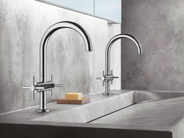 Silver kitchen taps with grey basin and bar of soap
