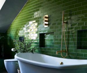 Green bathroom tiles with gold brassware and white sanitaryware