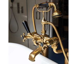 Gold bath tap with black extras