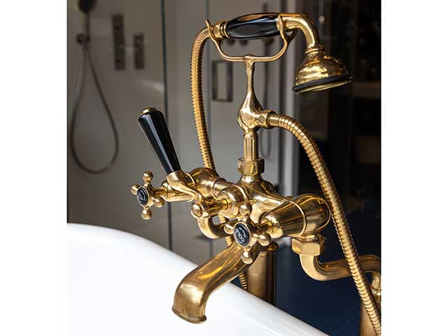 Gold bath tap with black extras