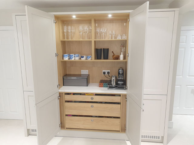 coffee station and drinks cabinet in an open plan kitchen with cream cabinets