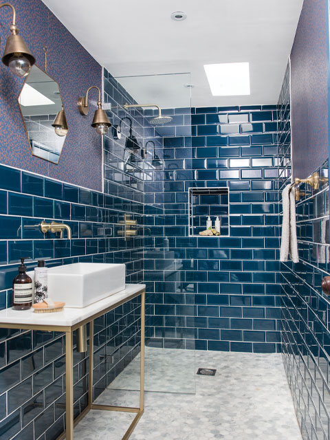 teal bathroom tiles with lilac accents and brass finishings 