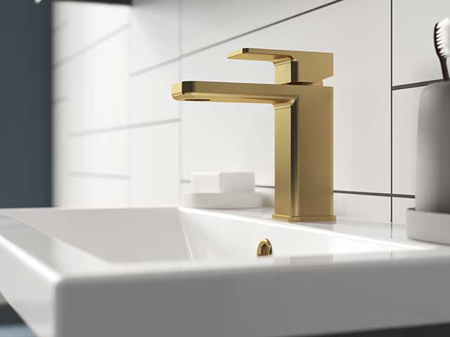 Gold square taps on white basin
