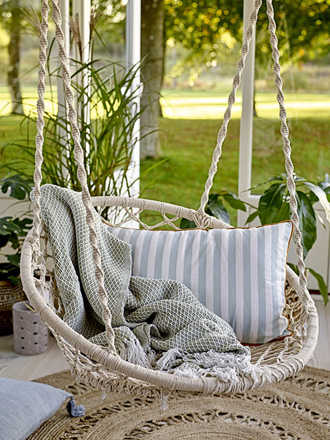 Macrame hanging outdoor chair in 70s boho trend