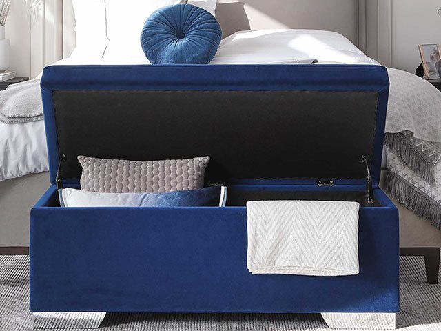 Bedroom storage ideas - blue velvet ottoman trunk at the foot of a bed