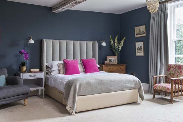 custom-made tall headboard in grey for a luxe navy bedroom