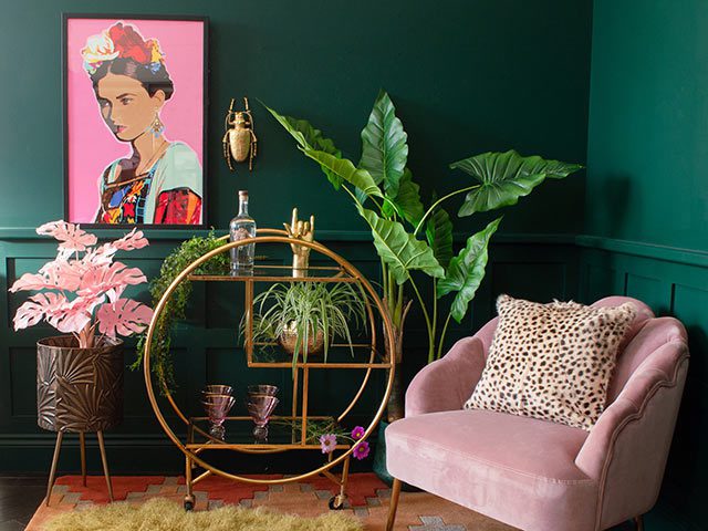 Frida Kahlo 70s boho print in living room with portable bar and houseplant