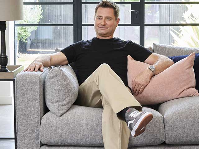 George Clarke Sofolofy on comfy chair with cushions