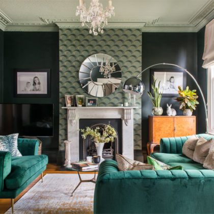 teal sofa and feature wall in living room
