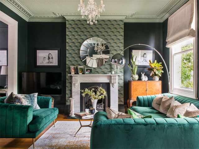 teal sofa and feature wall in living room