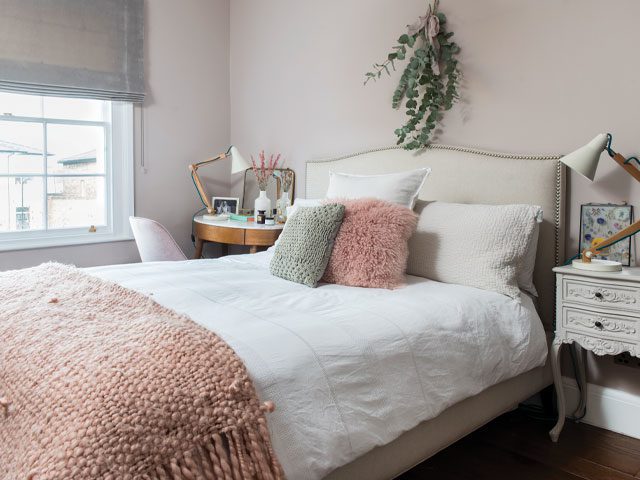 blush pink bedroom with white linen sheets and pink and grey accessories