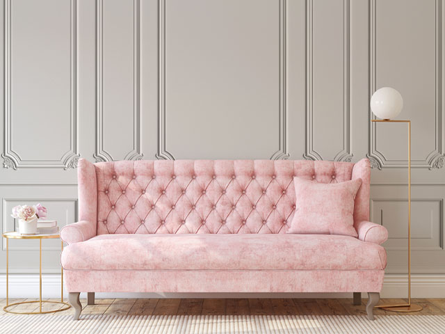 Bridgerton pink sofa against pebble-coloured wall panelling