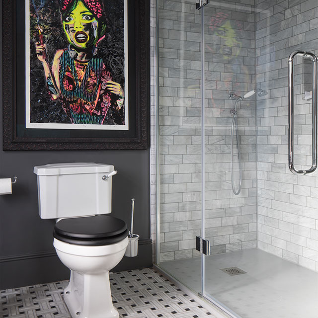 dark grey bathroom with colourful artwork