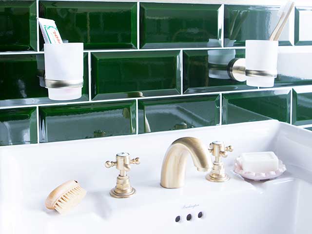 Green tiles and gold taps in white basin in Victorian bathroom makeover