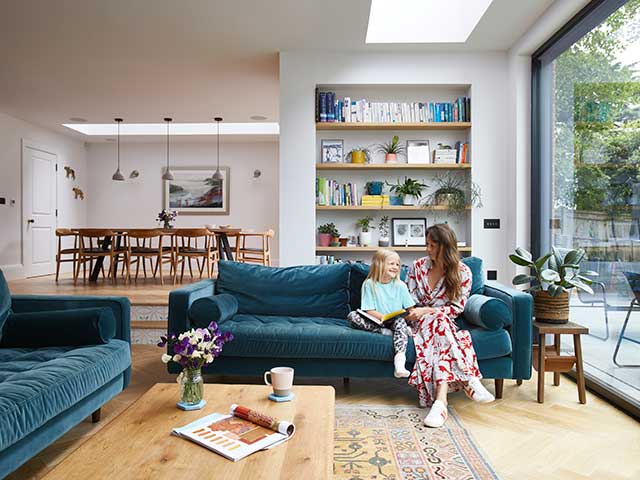 Ella Blackwell on the teal sofa at home in her Tunbridge Wells self-build