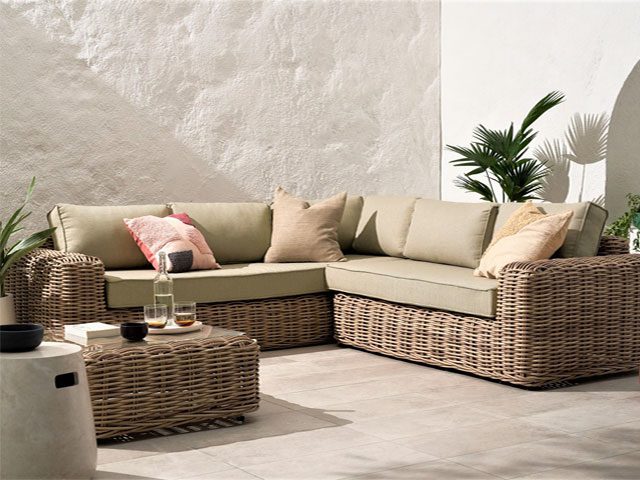 relaxed, slouchy rattan garden corner sofa with beige cushions