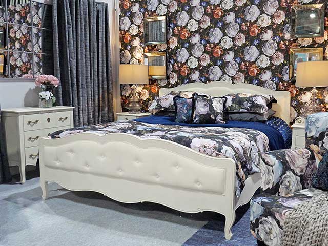 Ideal Home Show Scotland roomsets bedroom with floral wallpaper and bedding
