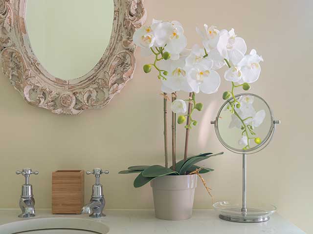 Coastal grandma faux flowers in bathroom