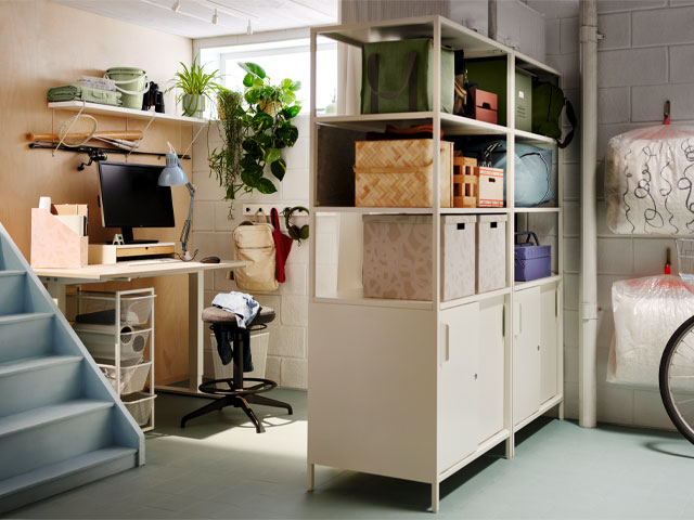 basement home office set up by Ikea with clever wall storage and cabinet as room divider