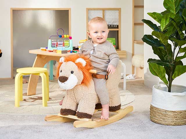 Baby Brody on lion rocker in playroom